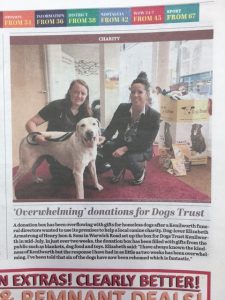 Newspaper clipping of article about donations made to Dogs Trust. Pictured is a Kenilworth funeral director, Dogs Trust employee and a golden Labrador.