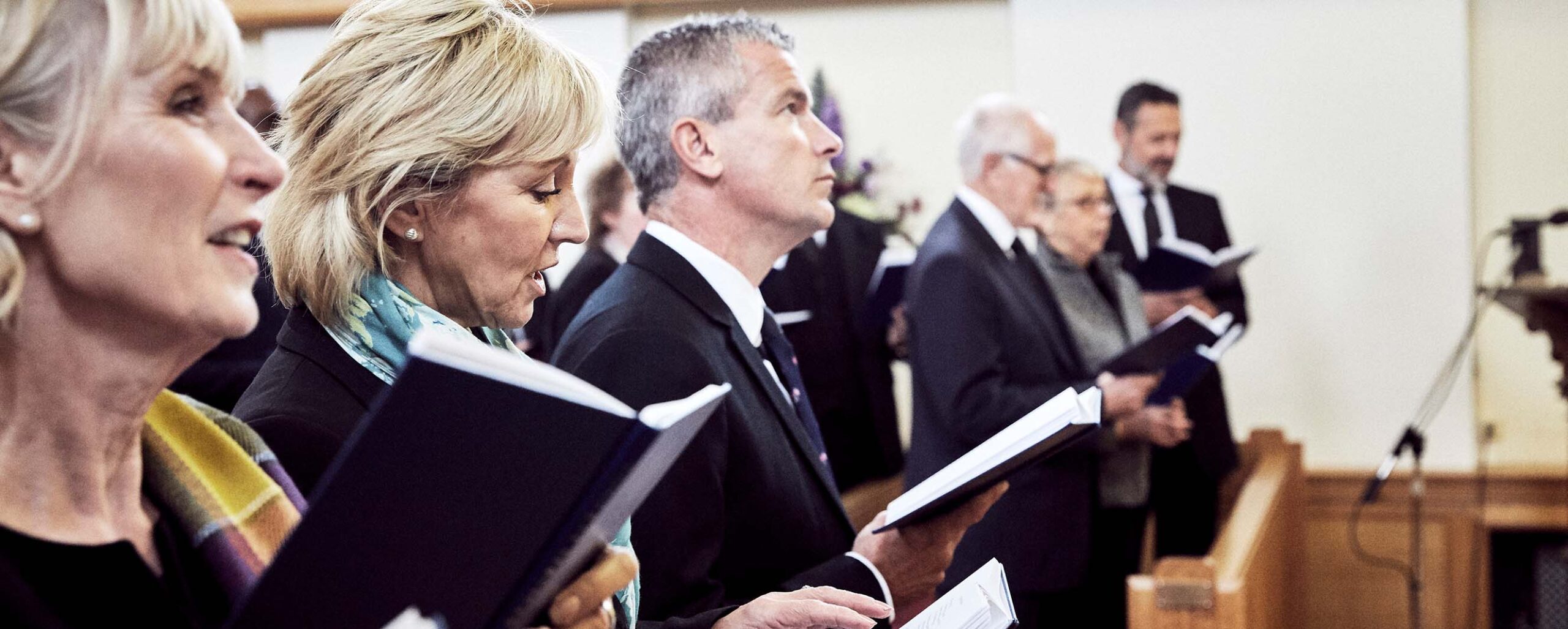 People singing a hymn at a funeral service