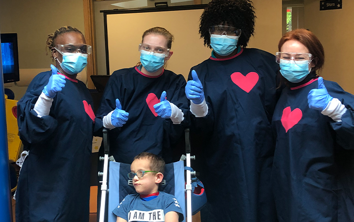 A group of people wearing medical masks and gloves.