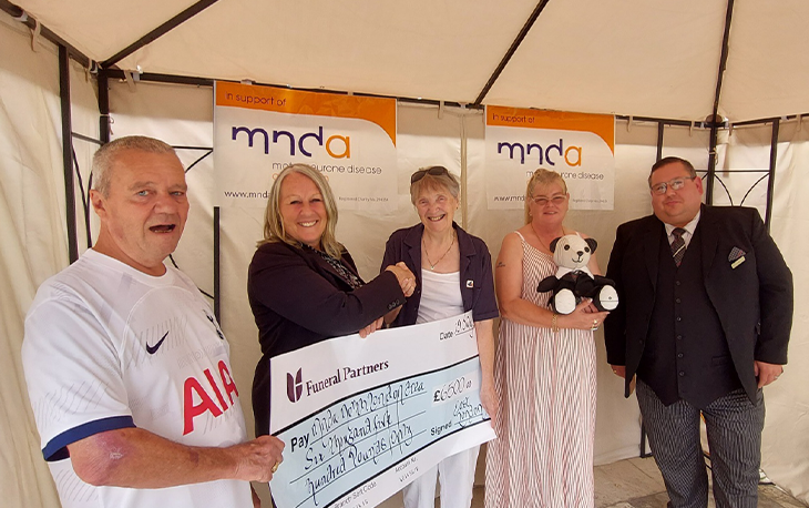 A group of people being awarded a check.