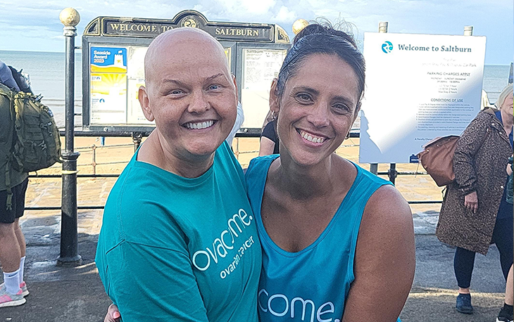 Two women smiling at the camera.
