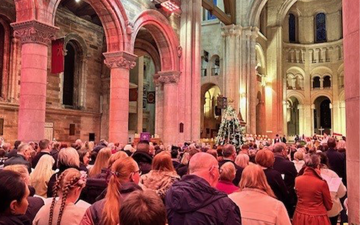 A bunch of people at an event inside Belfast Cathedral.