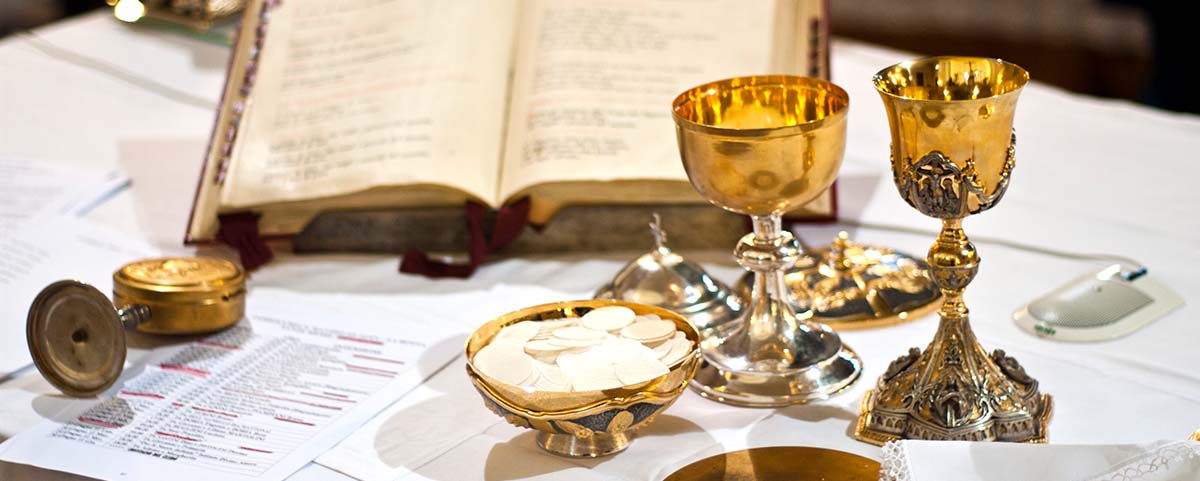 Bible, wine and wafers for traditional Catholic mass.