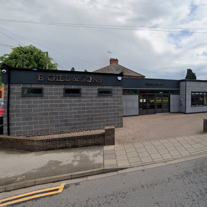 Entrance of E. Gill & Sons Funeral Directors with parking