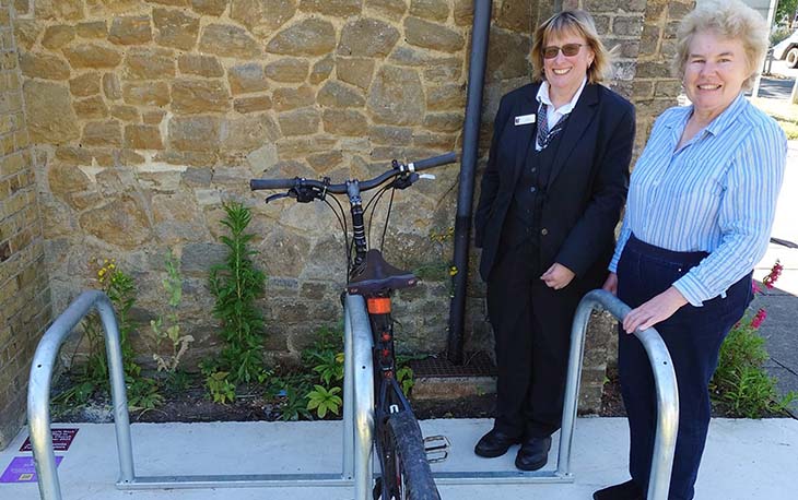 Two ladies standing next to new bike racks