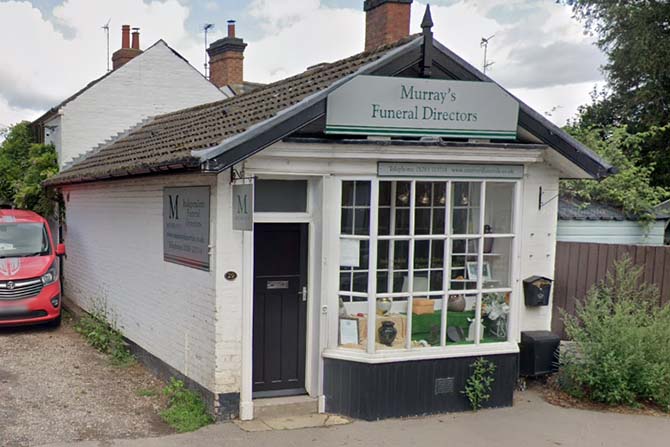 Entrance to Murray's Funeral Directors showing urns in the window